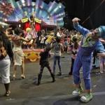 Ringling Bros. and Barnum & Bailey clowns dance with fans during a pre show for fans Saturday, Jan. 14, 2017, in Orlando, Fla. The Ringling Bros. and Barnum & Bailey Circus will end the 