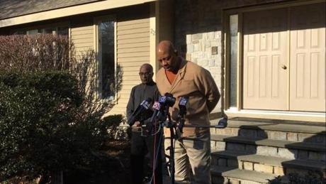 University of Massachusetts Boston Chancellor J. Keith Motley, right, spoke to reporters outside his Stoughton home, accompanied by family friend and neighbor Joseph Feaster, left.

