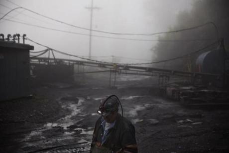 CLIMATE CHANGE: In this Thursday, May 12, 2016 photo, coal miner Scott Tiller walks through the morning fog before going underground in a mine less than 40-inches high in Welch, W.Va. For over a century, life in Central Appalachia has been largely defined by the ups and downs of the coal industry. There is a growing sense in these mountains that for a variety of reasons, economic, environmental, political, coal mining will not rebound this time. Coal's slump is largely the result of cheap natural gas, which now rivals coal as a fuel for generating electricity. Older coal-fired plants are being idled to meet clean-air standards. According to the Labor Department, there were 56,700 jobs in coal mining in March, down from 84,600 in March 2009, shortly after President Barack Obama entered office. There are stark differences between the two parties on energy and environment issues that underscore the sky-high stakes for both sides of the debate in the 2016 presidential race. Many environmental groups and Democrats fear a potential rollback of the Obama administration?s policies on climate change and renewable energy under a Republican president. Republicans all support coal production and enthusiastically back nuclear energy. They along with business groups are eager to boost oil and gas production following years of frustration with Obama. (AP Photo/David Goldman)
