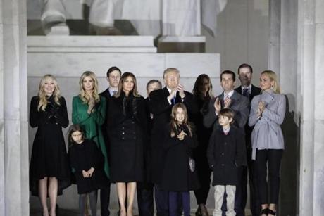 President-elect Donald Trump and his wife Melania Trump and family wave at the conclusion of the pre-Inaugural 