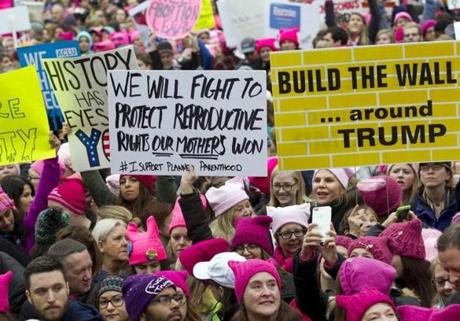 Women with bright pink hats and signs begin to gather early and are set to make their voices heard on the first full day of Donald Trump's presidency, Saturday, Jan. 21, 2017 in Washington. Organizers of the Women's March on Washington expect more than 200,000 people to attend the gathering. Other protests are expected in other U.S. cities. ( AP Photo/Jose Luis Magana)
