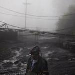 CLIMATE CHANGE: In this Thursday, May 12, 2016 photo, coal miner Scott Tiller walks through the morning fog before going underground in a mine less than 40-inches high in Welch, W.Va. For over a century, life in Central Appalachia has been largely defined by the ups and downs of the coal industry. There is a growing sense in these mountains that for a variety of reasons, economic, environmental, political, coal mining will not rebound this time. Coal's slump is largely the result of cheap natural gas, which now rivals coal as a fuel for generating electricity. Older coal-fired plants are being idled to meet clean-air standards. According to the Labor Department, there were 56,700 jobs in coal mining in March, down from 84,600 in March 2009, shortly after President Barack Obama entered office. There are stark differences between the two parties on energy and environment issues that underscore the sky-high stakes for both sides of the debate in the 2016 presidential race. Many environmental groups and Democrats fear a potential rollback of the Obama administration?s policies on climate change and renewable energy under a Republican president. Republicans all support coal production and enthusiastically back nuclear energy. They along with business groups are eager to boost oil and gas production following years of frustration with Obama. (AP Photo/David Goldman)
