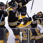 David Pastrnak (second from right) celebrated with Bruins teammates after his overtime goal.