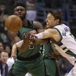 Milwaukee Bucks' Matthew Dellavedova, right, tries to knock the ball away from the Boston Celtics' Jaylen Brown during the first half of an NBA basketball game, Saturday, Jan. 28, 2017, in Milwaukee. (AP Photo/Jeffrey Phelps)