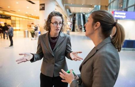 At Logan, immigration attorneys Susan Church (left) and Heather Yountz hung fliers offering free legal help to those affected by recent immigration orders.
