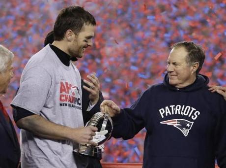 New England Patriots quarterback Tom Brady, left, holds the AFC Championship trophy as he celebrates with head coach Bill Belichick after the AFC championship NFL football game, Sunday, Jan. 22, 2017, in Foxborough, Mass. The Patriots defeated the the Pittsburgh Steelers 36-17 to advance to the Super Bowl. (AP Photo/Matt Slocum)
