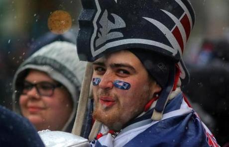 Boston, MA - 02/07/17 - Sam Macasay (cq) waited in a flying Elvis hat as fans line the route for the Patriots' 2017 Superbowl victory parade along Boylston Street in Boston. New England Patriots Super Bowl Parade 2017 boston globe staff (Lane Turner/Globe Staff) Reporter: (various) Topic: (08paradepic)
