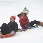 Libby Waterfall (right) and Annie Winter rode sleds on Boston Common Thursday. 