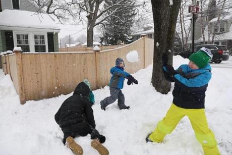 Children played in the snow  in Milton; Roman Padera, 10, right, braced for a snowball thrown by Nolan Patel, 5. 

