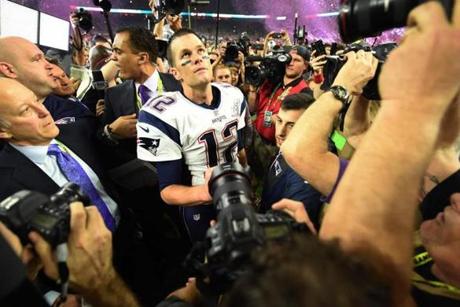 (FILES) This file photo taken on February 05, 2017 shows Tom Brady of the New England Patriots as he looks on after defeating the Atlanta Falcons 34-28 in overtime during Super Bowl 51 at NRG Stadium in Houston, Texas. Tom Brady may have set a slew of records in the New England Patriots' Super Bowl miracle win against the Atlanta Falcons -- but the veteran quarterback says his display was far from his greatest game. Brady, 39, secured a record fifth Super Bowl title after helping the Patriots overturn a 25-point deficit to secure a thrilling overtime win over the Falcons in Houston on February 5. The Patriots star threw a Super Bowl record 466 yards and earned a record fourth Super Bowl MVP award in the win. / AFP PHOTO / Timothy A. CLARYTIMOTHY A. CLARY/AFP/Getty Images
