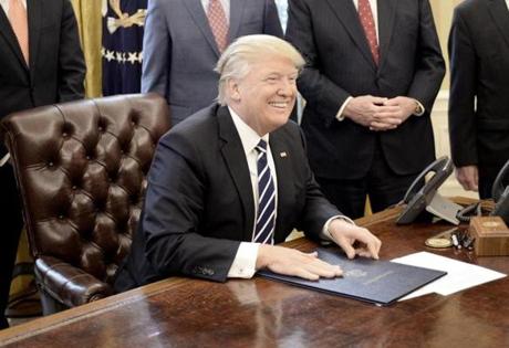WASHINGTON, D.C. - FEBRUARY 14: (AFP-OUT) U.S. President Donald Trump smiles after signing H.J. Res. 41 in the Oval Office of the White House on February 14, 2017 in Washington, DC. The resolution nullifies a rule in the Dodd-Frank Act that 