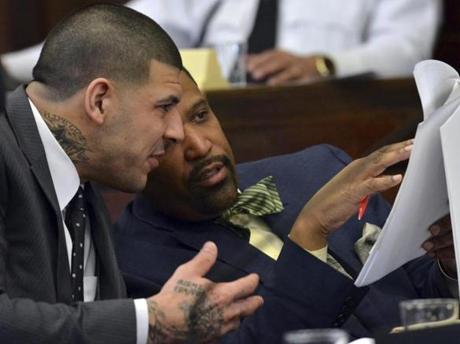 Aaron Hernandez, left, and defense attorney Ronald Sullivan go over paperwork during motion hearings prior to Hernandez's double murder trial in Boston, Monday, Feb. 13, 2017. (Chris Christo/The Boston Herald via AP, Pool)
