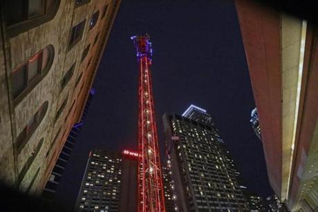 The glowing crane near the Prudential Center was the idea of Richard Friedman?s, CEO of Carpenter & Co., developer of a luxury high-rise. 
Each light strand on the crane can change to one of 10 colors. The developer won?t say how much this light show in the sky costs, but described it as nominal.
