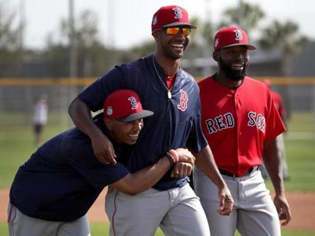 Fort Myers, FL - 2/18/2017 - Boston Red Sox outfielder Chris Young (30) has Boston Red Sox right fielder Mookie Betts (50) under his wing as they share a laugh following a drill on Saturday. Red Sox Spring Training. Day Six at Jet Blue Park in Fort Myers, FL. - (Barry Chin/Globe Staff), Section: Sports, Reporter: Peter Abraham, Topic: 19Red Sox, LOID: 8.3.1646383778.
