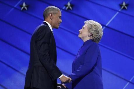President Barack Obama and Democratic Presidential candidate Hillary Clinton hold hands on stage after the president addressed the delegates during the third day session of the Democratic National Convention in Philadelphia, on July 27, 2016. (AP Photo/Carolyn Kaster)

