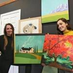 Amanda Abbott (left) and Leonie Little-Lex are among a group of local artists who sold more than $4,000 of watercolors, ceramics, prints, and jewelry to benefit Greater Boston Legal Services and the Refugee & Immigrant Assistance Center.