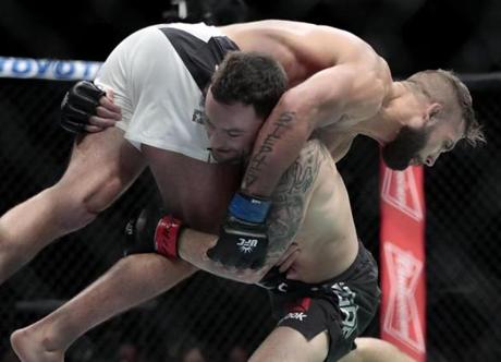 Frankie Edgar lifted Jeremy Stephens during a featherweight bout at UFC 205 at Madison Square Garden.

