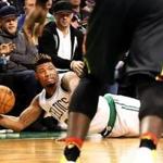 Celtics guard Marcus Smart slides out of bounds ? near Patriots receiver/spectator Julian Edelman ? during the C?s loss to the Hawks at TD Garden Monday.