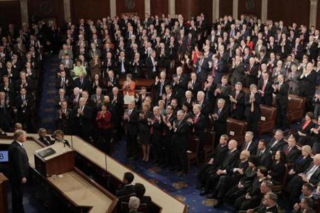 Republicans Congressional members stand and applaud as Democratic members sit as President Donald Trump pauses during his address to a joint session of Congress on Capitol Hill in Washington, Tuesday, Feb. 28, 2017. (AP Photo/J. Scott Applewhite)

