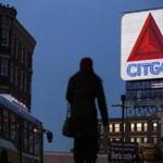 Pedestrians walked through Kenmore Square as sunlight fell on the Citgo sign on Monday. 