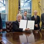 US President Donald Trump, seated, after signing an executive order withdrawing the US from the Trans-Pacific Partnership in January.