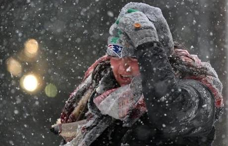 SNOW SLIDER3 BOSTON, MA - 3/14/2017: A REAL PATRIOT....woman holds onto her hat at Court Street Boston.... A March snowstorm hits the Boston area (David L Ryan/Globe Staff Photo) SECTION: METRO TOPIC 15storm
