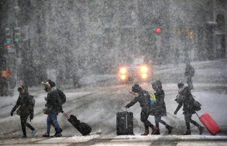 SNOW SLIDER3 BOSTON, MA - 3/14/2017: TRAVELERS in the thick of it make their way along Congress Street. A March snowstorm hits the Boston area (David L Ryan/Globe Staff Photo) SECTION: METRO TOPIC 15storm
