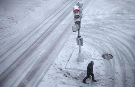 SNOW SLIDER3 Boston, MA -- 3/14/2017 - A pedestrian crosses Huntington Street as snow falls in Boston. (Jessica Rinaldi/Globe Staff) Topic: 15storm Reporter: 
