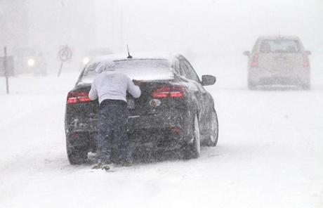 SNOW SLIDER3 Worcester, Ma., 03/14/17, A man tried to help a woman's whose car was not doing well in the snow in downtown Worcester. Suzanne Kreiter/Globe staff
