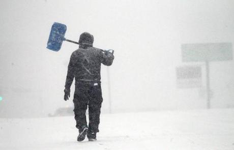 A man with a shovel walked in near-white out conditions in Worcester.

