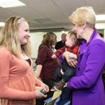 Senator Elizabeth Warren greeted patients Seana Harris and three-month-old Slater Sundquist during her visit to the Manet Community Health Center on Monday in Quincy. 