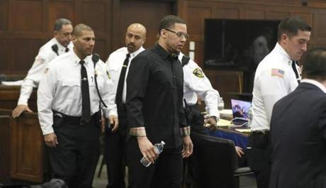 Alexander Bradley enters the courtroom and passes the defense table for his second day of testimony during former New England Patriots football player Aaron Hernandez' double murder trial in Suffolk Superior Court, Tuesday, March 21, 2017, in Boston. Hernandez is on trial for the July 2012 killings of Daniel de Abreu and Safiro Furtado who he encountered in a Boston nightclub. The former New England Patriots NFL football player is already serving a life sentence in the 2013 killing of semi-professional football player Odin Lloyd. (Pat Greenhouse /The Boston Globe via AP, Pool)
