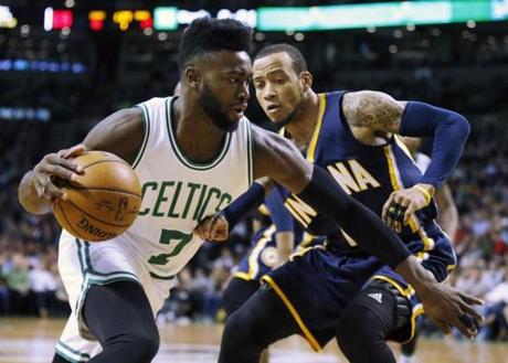 Boston Celtics' Jaylen Brown (7) drives past Indiana Pacers' Monta Ellis during the first quarter of an NBA basketball game in Boston, Wednesday, March 22, 2017. (AP Photo/Michael Dwyer)
