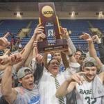 Babson's Joey Flannery (32), teammates and coach Stephen Brennan, center, celebrate after winning the NCAA Division III men's college basketball championship game against Augustana on Saturday, March 18, 2017, in Salem, Va. Babson won 79-78. (AP Photo/Don Petersen)