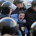 Police detained a demonstrator during an opposition rally in Moscow on Sunday, one of hundreds arrested nationwide. 