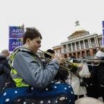 Musicians play their instruments across the street from the State House during Arts Matter Advocacy Day.