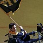 Actor Jake Gyllenhaal, portraying Boston Marathon bombings survivor Jeff Bauman, waves a flag while filming a scene from ?Stronger? on the ice of Boston Garden on April 5, 2016. 