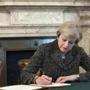 epa05876306 A handout photo made available by 10 Downing Street on 29 March 2017 shows British Prime Minister Theresa May signing a letter of notification to the President of the European Council setting out the United Kingdom's intention to withdraw from the European Union at 10 Downing Street in London, Britain, 28 March 2017. May will deliver a statement to parliament in London on 29 March. EPA/JAY ALLEN / NO10 / MOD / HANDOUT MOD Crown Copyright 2016 © HANDOUT EDITORIAL USE ONLY