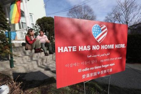 Jason and Elizabeth DelPorto with their anti-hate sign in their Watertown front yard. 
