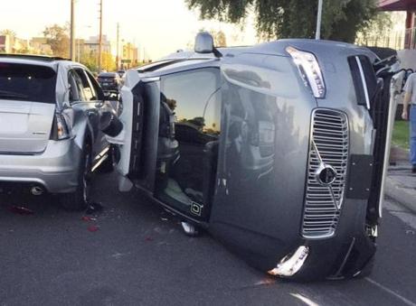 This March 24, 2017, photo provided by the Tempe Police Department shows an Uber self-driving SUV that flipped on its side in a collision in Tempe, Ariz. The crash serves as a stark reminder of the challenges surrounding autonomous vehicles in Arizona. (Tempe Police Department via AP)
