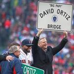 Massachusetts Governor Charlie Baker held up the sign that would soon be posted on the bridge. 