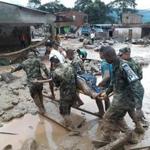 Soldiers carried a victim on a stretcher Saturday after a deluge struck Mocoa, Colombia. 