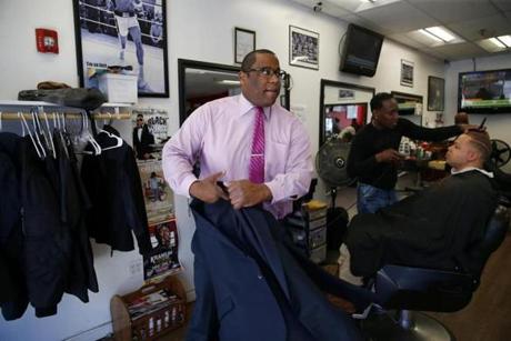 City Councilor Tito Jackson put on his coat as he left Top Notch Barber Shop in Boston after stopping in for a haircut last month.
