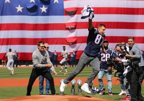 Boston-04/03/2017- Opening Day at Fenway Park- Red Sox played the Pirates-Patriots Rob Gronkowski takes Qb Tom Brady's Jersey as they arrived at the mound for pregame ceremonies. Brady threw out the first pitch. John Tlumacki/Globe staff(sports)
