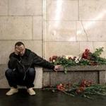 A mourner paused Tuesday on a St. Petersburg subway station platform where flowers were left in memory of the victims of a bombing that killed 14 and injured 64.
