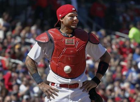 St. Louis Cardinals catcher Yadier Molina stands with his hands on his hips as a ball is somehow stuck to his chest protector during the seventh inning of a baseball game against the Chicago Cubs on Thursday, April 6, 2017, in St. Louis. The ball was stuck to Molina's chest protector on a dropped third strike allowing the Cubs' Matt Szczur to reach first base when Molina couldn't find the ball. (AP Photo/Jeff Roberson)
