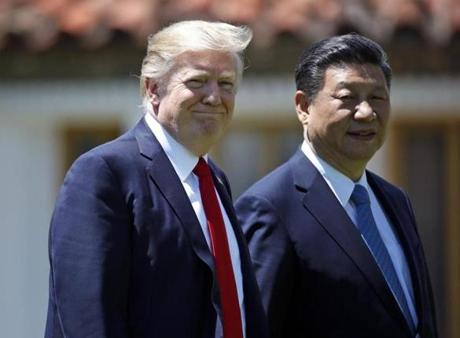 President Donald Trump and Chinese President Xi Jinping walk together at Mar-a-Largo on Friday. 
