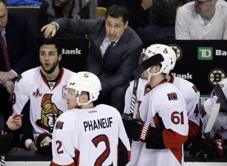 Ottawa Senators coach Guy Boucher instructs his players during the third period of the team's NHL hockey game against the Boston Bruins, Thursday, April 6, 2017, in Boston. (AP Photo/Elise Amendola)
