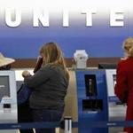 A United Airlines customer service representative helped passengers to reschedule their travel plans at O?Hare International Airport in Chicago in 2011.