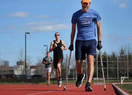 J. Alain Ferry used a pair of crutches and a stability brace while working out at McCurdy Track in Allston.
